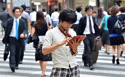 University student Akihiro Matsumura uses his tablet computer to write kanji in Tokyo. Photo: AFP