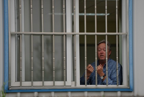 Chip Starnes spoke to media from a window during his lock-up on Tuesday. Photo: AFP