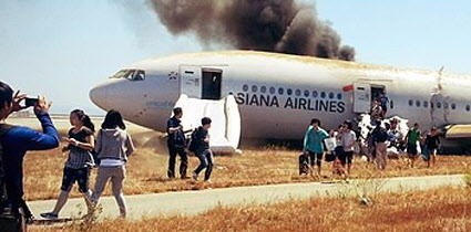 Smoke billows from the plane as passengers make their escape down emergency slides. This picture was taken by a survivor. Photo: EPA