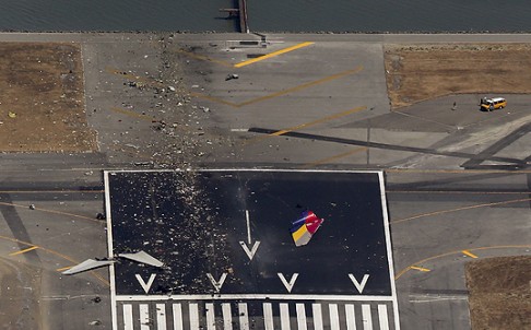 Debris from an Asiana Airlines Boeing 777 plane is seen on a runway. Photo: Reuters