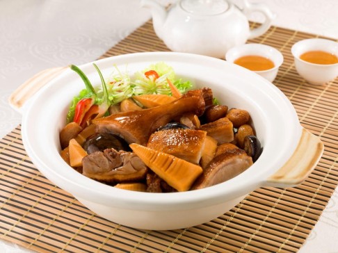 Bamboo shoots and ginger in clay pot.