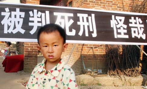 At Zeng's funeral, a banner proclaimed that his death sentence was ridiculous. Photo: Mimi Lau