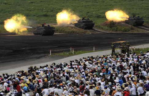 Spectators watch Self-Defence Forces' tanks during annual exercises near Mt Fuji. Photo: EPA