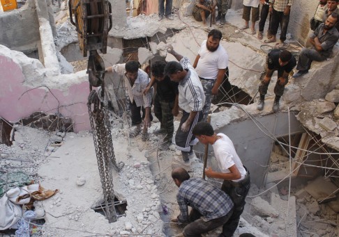 Men search for survivors amid the rubble of collapsed buildings after what activists said was shelling by forces loyal to Syria's President Assad in Aleppo. Photo: Reuters