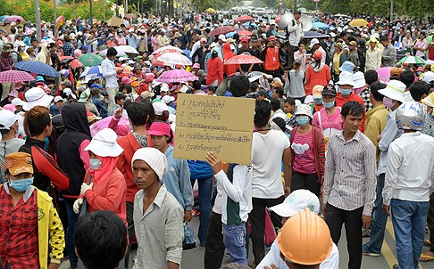 Cambodian garment factory workers block a street during a protest in front of Phnom Penh Municipal Hall on Thursday. Photo: AFP