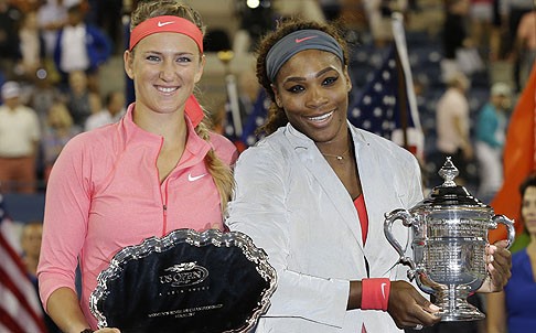 Williams holds her winner's trophy as Azarenka (right) holds the runners-up trophy. Photo: Reuters