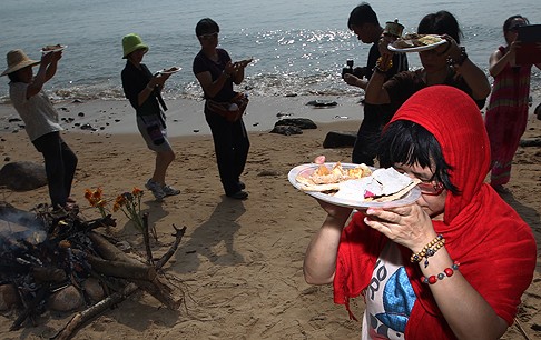 Residents perform prayer rituals on Lamma Island's Nga Kau Wan beach on Tuesday. Photo: Felix Wong