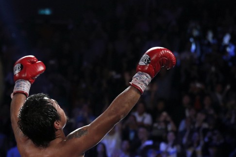 Pacquiao of the Philippines celebrates his victory over Rios of the U.S. during their WBO International 12-round welterweight boxing title fight. Photo: Reuters
