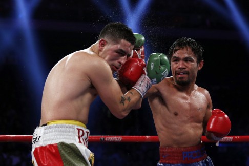 Pacquiao of Philippines punches Rios of the U.S. during their WBO International 12-round welterweight boxing title fight at the Venetian Macao hotel in Macau. Photo: Reuters