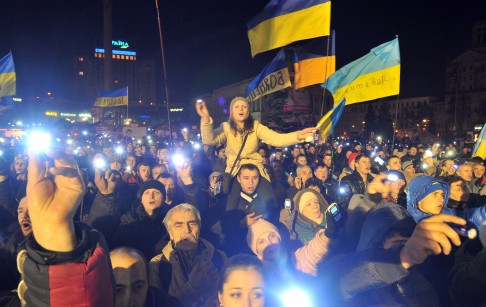 People light electric torches and phones during a night rally of the opposition on Independence Square in Kiev early on Wednesday, after Ukraine announced the Russian bailout. Photo: AFP