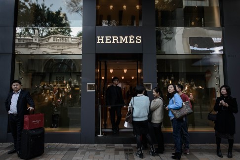 Tourists queuing in front of a luxury shop in a popular shopping district in Hong Kong. Photo: AFP