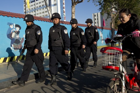 Armed policemen patrol on a street near the Kunming Railway Station where more than 10 assailants slashed scores of people with knives and machetes on Saturday night in Kunming. Photo: AP