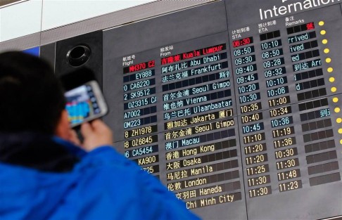 An information board at Beijing airport shows the flight was "delayed". Photo: Reuters