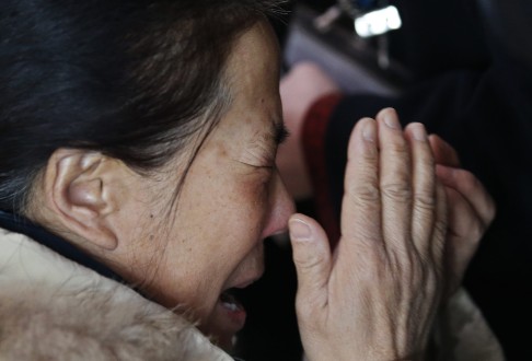 A relative of a passenger onboard Malaysia Airlines flight MH370 cries at the Beijing Capital International Airport. Photo: Reuters