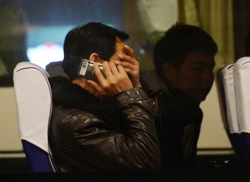 Relatives of passengers from the missing Malaysia Airlines Boeing 777-200 plane wait inside a bus at the Lido Hotel in Beijing. Photo: AFP