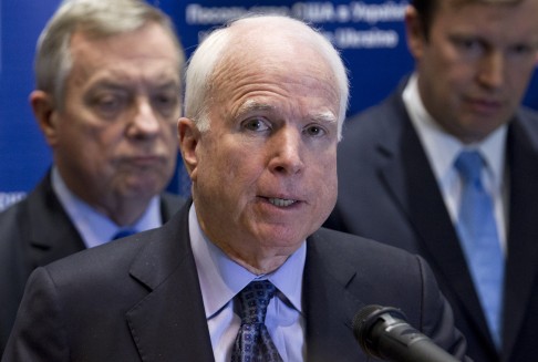 U.S. Sen. John McCain, centre, speaks during a news conference in Kiev, Ukraine. Photo: AP