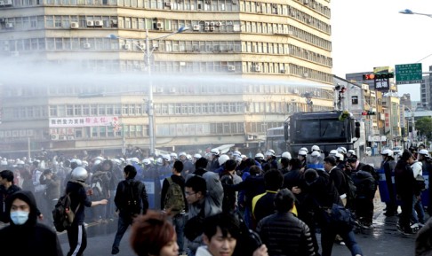 Riot police use water cannon to disperse protesters near the Cabinet compound in Taipei. Photo: EPA