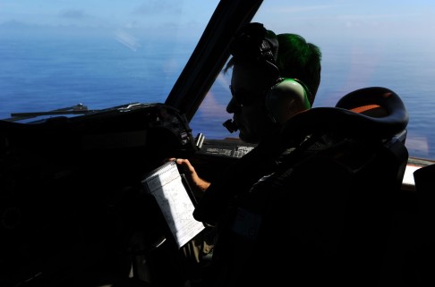 A Royal Australian Air Force pilot looks out from the cockpit of a AP-3C Orion as part of the squadron's search over the southern Indian Ocean for the missing Malaysian Airlines flight. Photo: Reuters