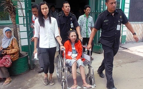 Indonesian maid Erwiana Sulistyaningsih, 23, is wheeled out of hospital after being discharged from hospital on February 5. Photo: AFP 