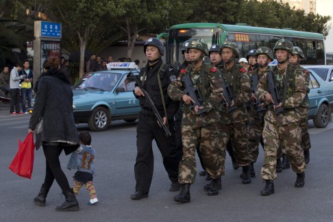 Armed police and paramilitary police patrol the streets near the Kunming Railway Station after the terrorist attack on March 1. Photo: AP