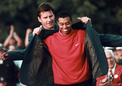 Tiger Woods receives his green jacket from the previous year's winner Nick Faldo at the Augusta National Golf Club in 1997. Photo: AP