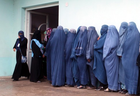 Women voters wait in a segregated line at a polling station in Takhar under tight security. Photo: EPA