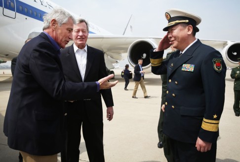 US Secretary of Defence Chuck Hagel (left) is welcomed by Rear Admiral Guan Youfei (right), Director of Foreign Affairs Office of the Chinese Defense Ministry and US Ambassador to China, Max Baucus (next to Hagel), upon his arrival at Qingdao International Airport. Photo: AFP