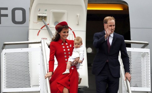 The family disembark from their plane amid wind and rain. Photo: Reuters