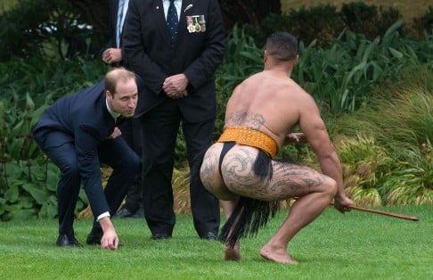 Britain's Prince William picks up the dart from a Maori warrior. Photo: AFP
