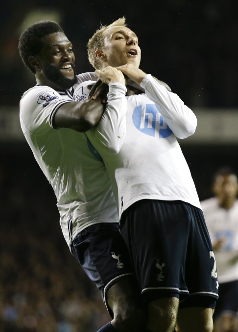 Christian Eriksen, right, celebrates scoring a goal with Emmanuel Adebayor. Photo: AP