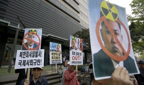 South Korean protesters hold pictures of Kim Jong-un during an anti-North Korea rally. Photo: AP