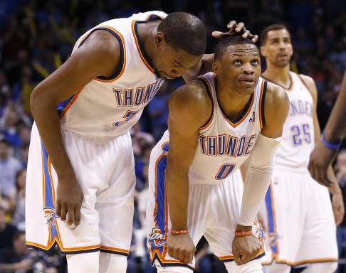 Oklahoma City Thunder forward Kevin Durant pats teammate Russell Westbrook on the head. 
