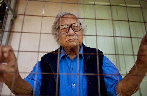 Win Tin wears a blue prison shirt in solidarity with activists who are still jailed at his home in Yangon. Photo: AP