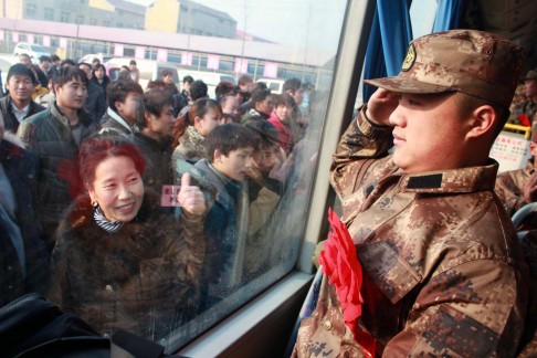 A recruit salutes his mother as he heads to camp. Photo: Xinhua
