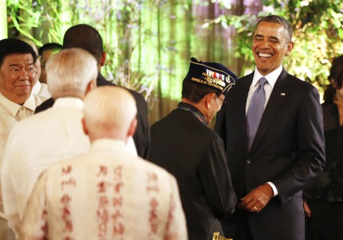 Obama greets former President Fidel Ramos, who once pardoned fellow dinner guest Senator Gringo Honasan for masterminding a coup in 1987 in which President Aquino was shot. Photo: Reuters