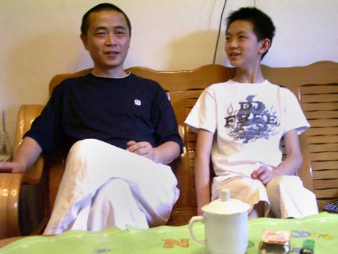 An undated photo of Huang Qi with his son at their home in Chengdu. Photo: AFP