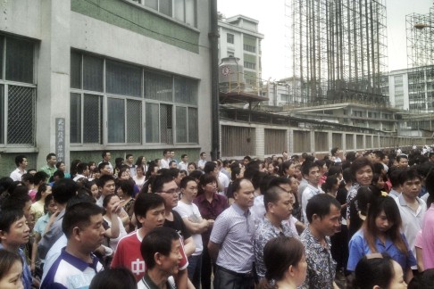 Workers protest at the Yue Yuen plant. Photo: Reuters
