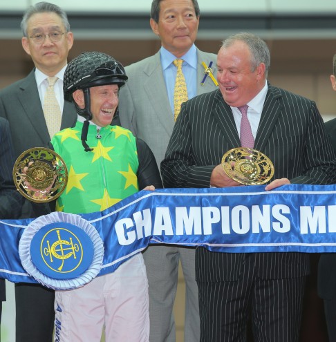 Jockey Anton Marcus and trainer Mike De Kock share a laugh at the presentation for the Champions Mile.