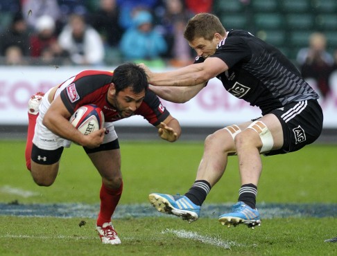Canada's Philip Mack is tackled by New Zealand's Scott Curry. 