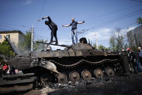 Rebels burned a Ukrainian army armoured vehicle. Photo: Reuters
