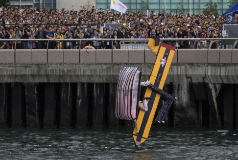 A participant operates "Teacher Killer", a self-made flying machine, during the Red Bull Flugtag event. Photo: Reuters