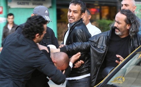 Turkish Plain clothes police officers detain a protester during a demonstration blaming the ruling AK Party government for the mining disaster. Photo: AFP