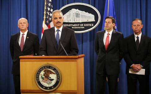 Attorney General Eric Holder, accompanied by, from left, US Attorney for Western District of Pennsylvania David Hickton, Assistant Attorney General for National Security John Carlin, and FBI Executive Associate Director Robert Anderson, speaks at a news conference at the Justice Department in Washington. Photo: AP