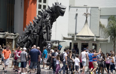A 6 metre statue of Godzilla towers over visitors after it was unveiled in the forecourt of the TCL Chinese Theatre in Hollywood earlier this month. Photo: AFP