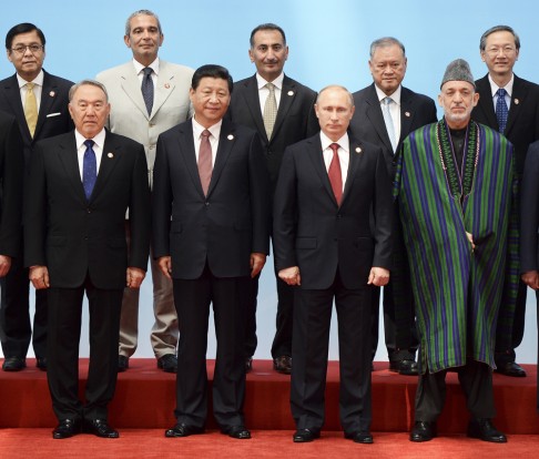 Chinese President Xi Jinping, front row second left, poses with leaders front row from left, Kazakhstan President Nursultan Nazarbayev, Xi, Russian President Vladimir Putin and Afghan President Hamid Karzai, and others pose for a group photo before the opening ceremony at the CICA summit in Shanghai. Photo: AP
