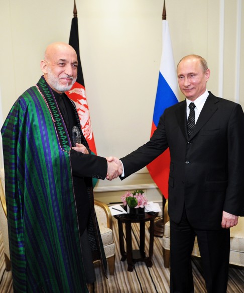 Russia's President Vladimir Putin (right) shake hands with Afghan President Hamid Karzai during a meeting at the sidewalks of the CICA summit. Photo: AP