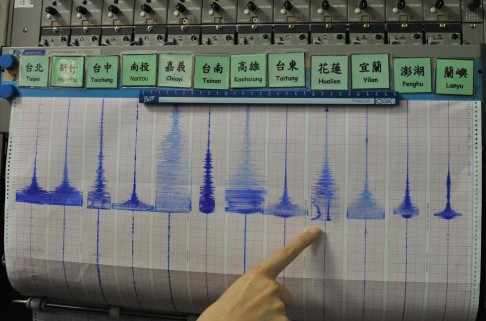 A staff member of the Seismology Center, points at a seismic chart following an earthquake at the central Weather Bureau. Hualien was the epicentre. Photo: AFP