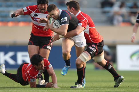 Hong Kong's Lloyd Jones tries to break through the Japanese defence. Photo: SCMP Pictures<br />
