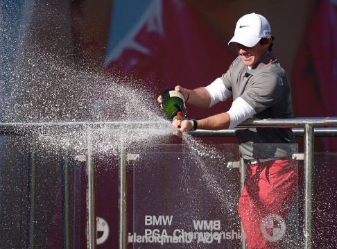 Rory McIlroy sprays champagne after his win. Photo: AP