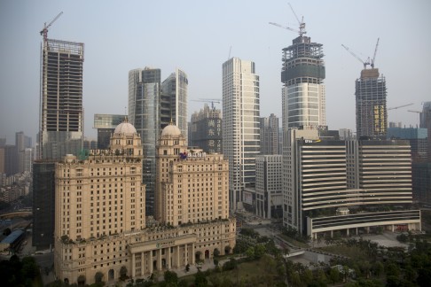 However most migrant will still not be allowed to settle in the province's two largest cities, Guangzhou (above) and Shenzhen. Photo: Bloomberg 